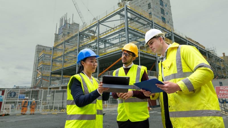 Architecture And Construction Superintendent Reviewing Project Outdoors